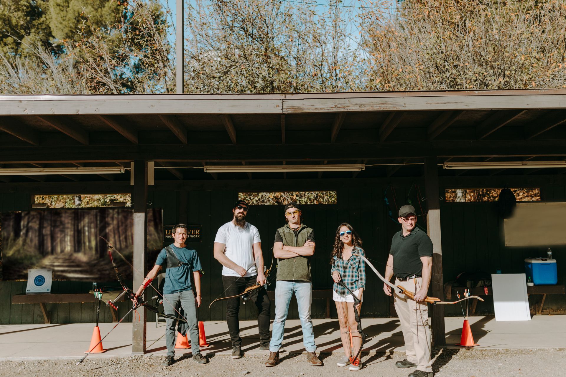 A Group of People Holding Bows and Arrows on Practice Range