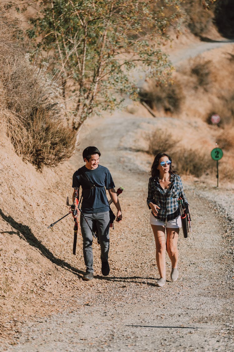 A Man And A Woman Carrying Bows And Arrows 