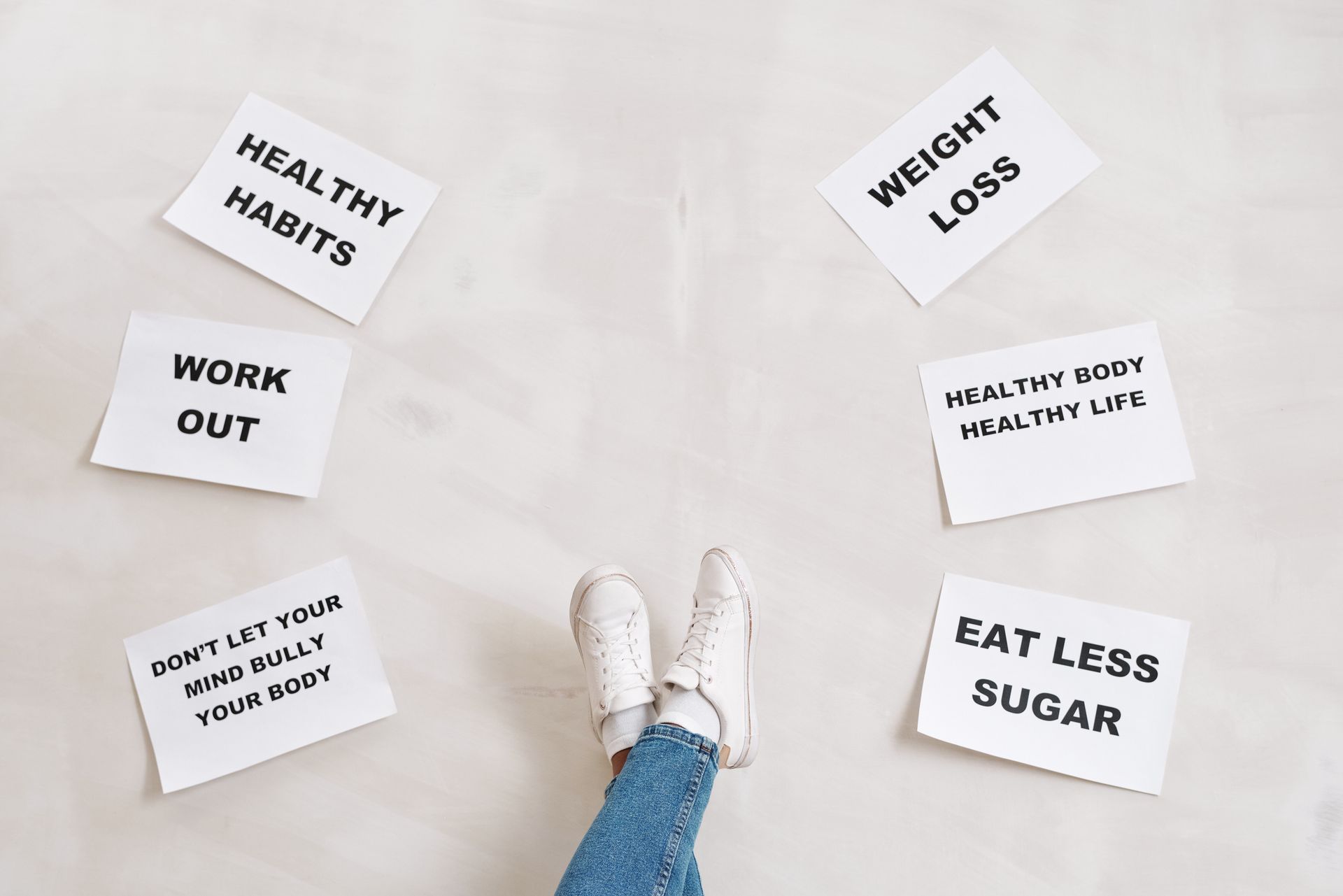 Inspirational health and fitness messages with shoe-clad feet, promoting healthy habits and wellbeing.