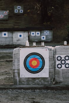 Close-up of archery targets with colorful bullseye in an outdoor range setting.