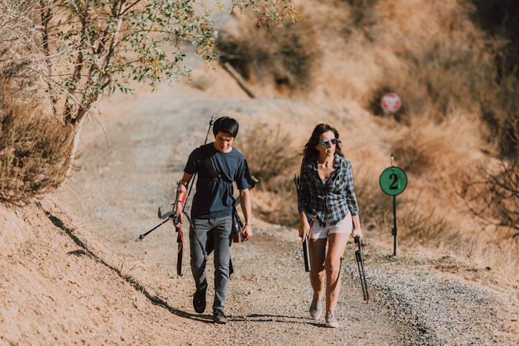 Man And Woman Carrying Bows And Arrows 