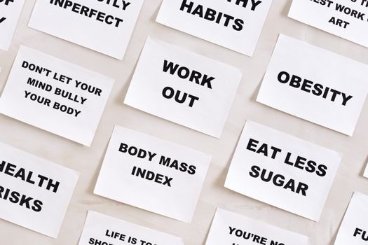 Flat lay of motivational health quotes on paper, promoting healthy habits and self-care.