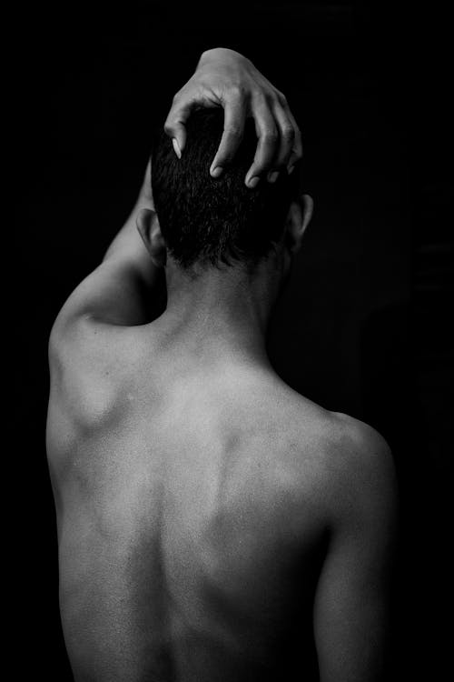 A Back View of a Topless Man