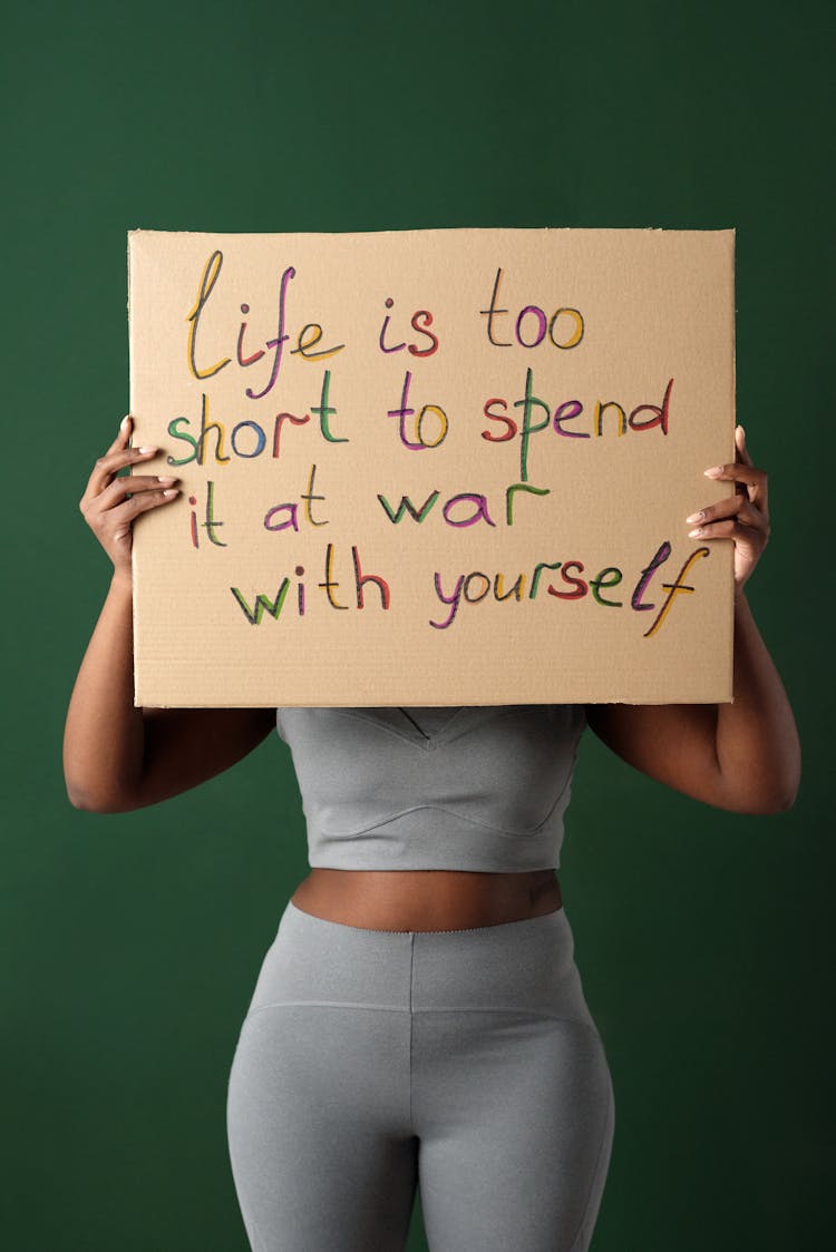 Woman Holding Handmade Placard Over Face