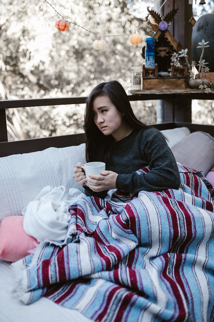 A Sad Woman Holding A Cup Of Coffee 