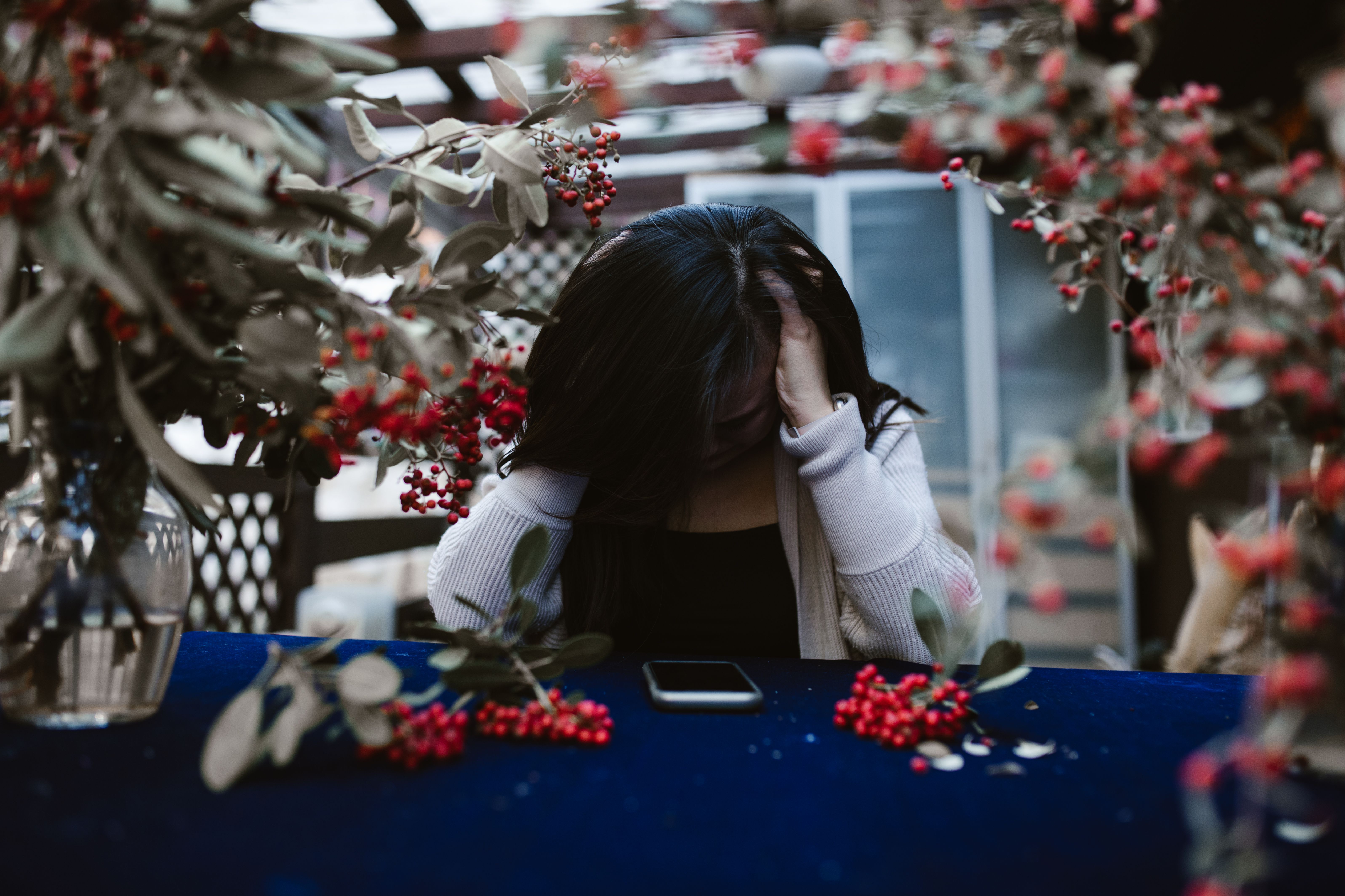 stressed person looking at phone worried