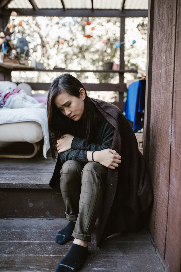 Sad Woman Sitting On The Corner 