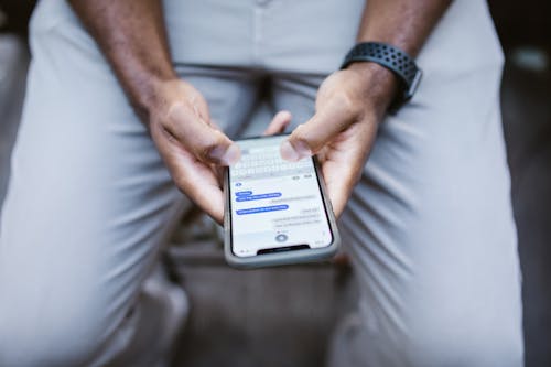 Man's Thumbs Typing on a Smartphone