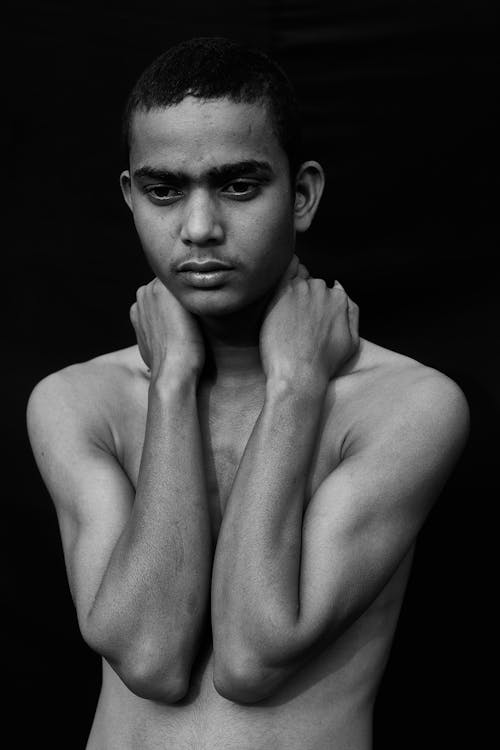 Free Topless Man With Hands Over Shoulder Looking Down Stock Photo