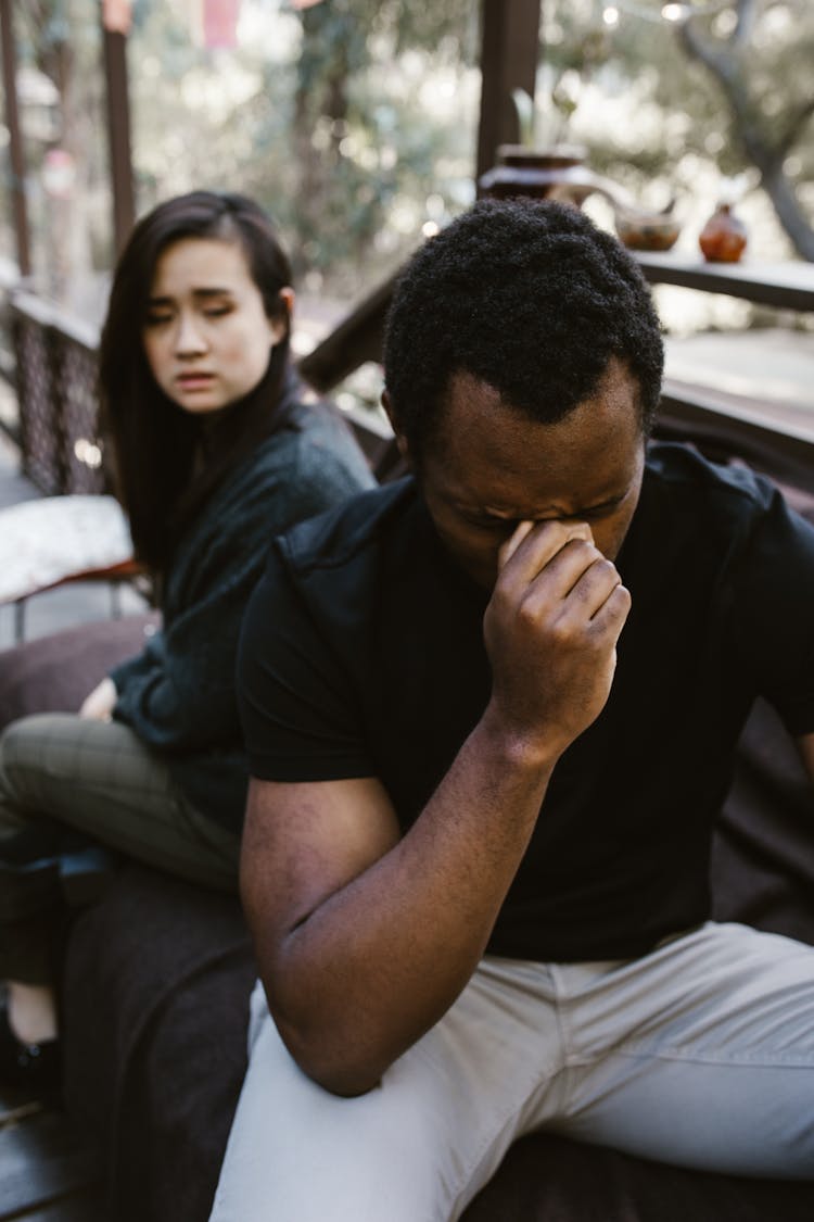 Woman Sitting Beside The Crying Man 