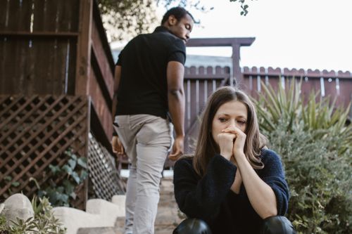 Free A couple facing emotional struggles captured in an outdoor setting. Stock Photo