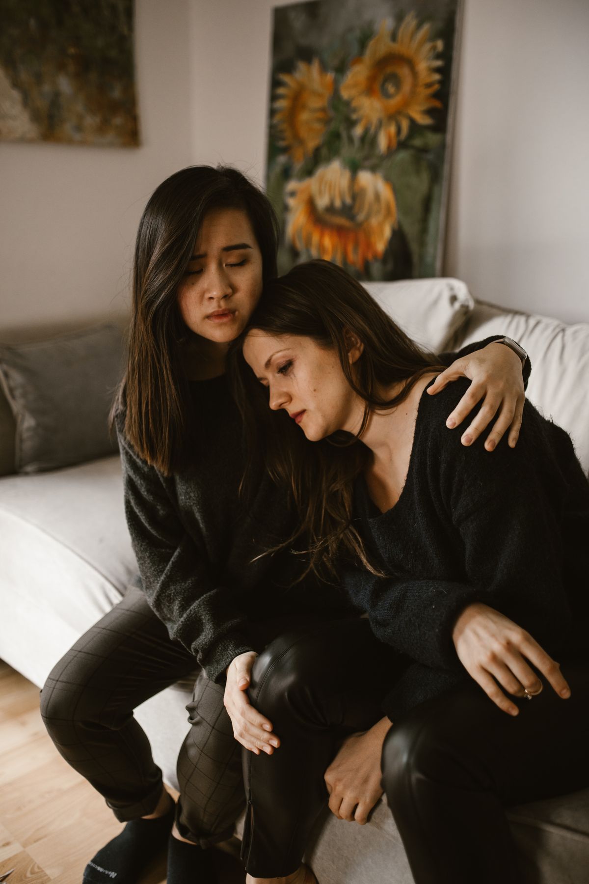 Woman being comforted by a friend after discovering infidelity, first steps toward support Woman being comforted by a friend after discovering infidelity, first steps toward support