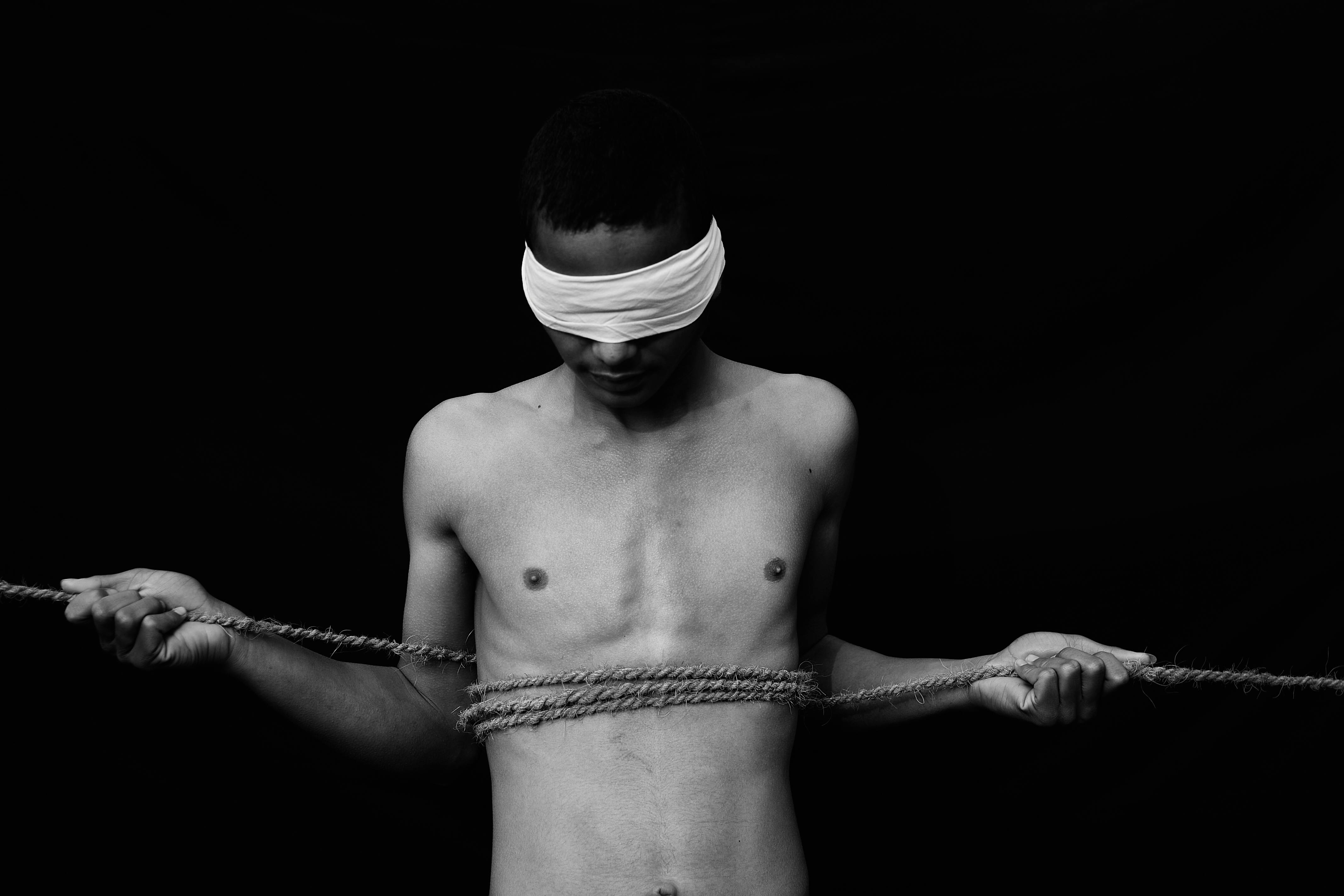 blindfolded man with bare chest