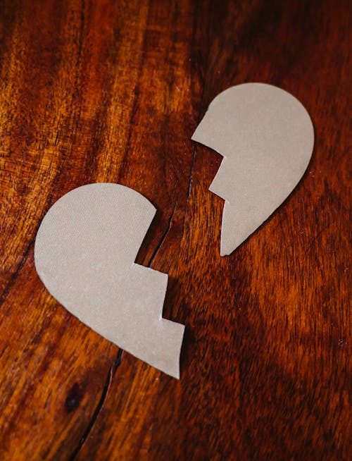 Free Broken Heart Cardboard on Brown Wooden Table Top Stock Photo