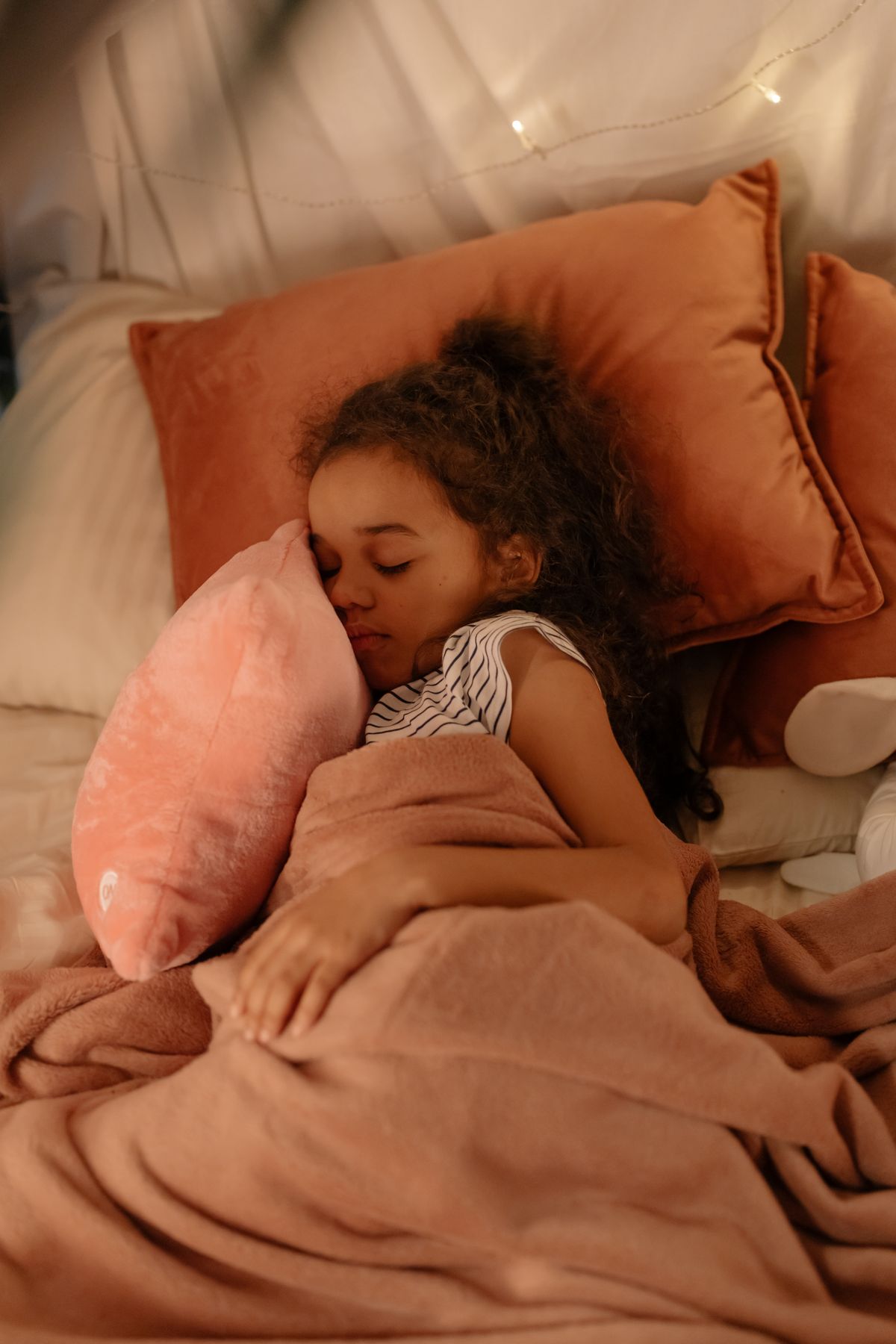 Child sleeping soundly with favorite stuffed animal