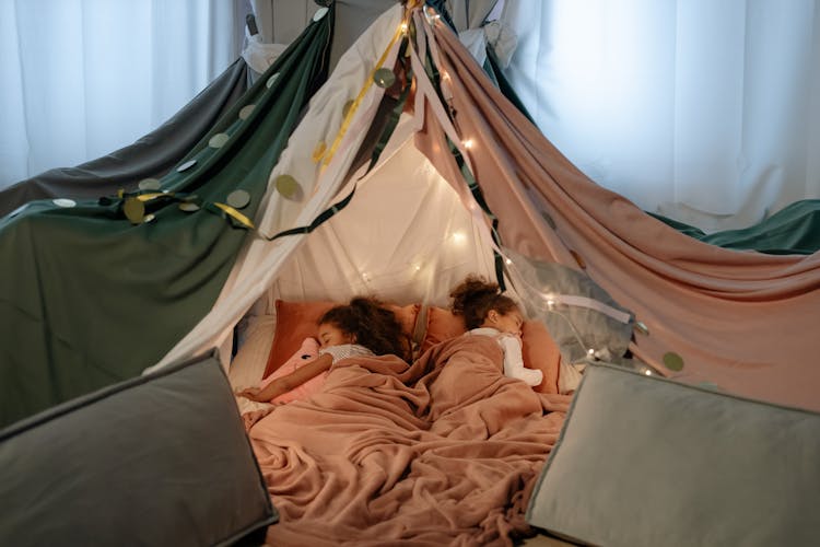 Young Girls Sleeping While Lying In The Tent