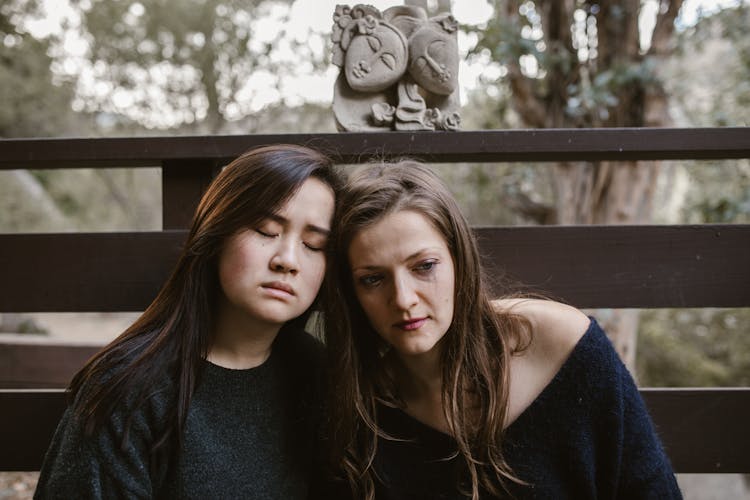 Women Grieving Together In Black Clothes