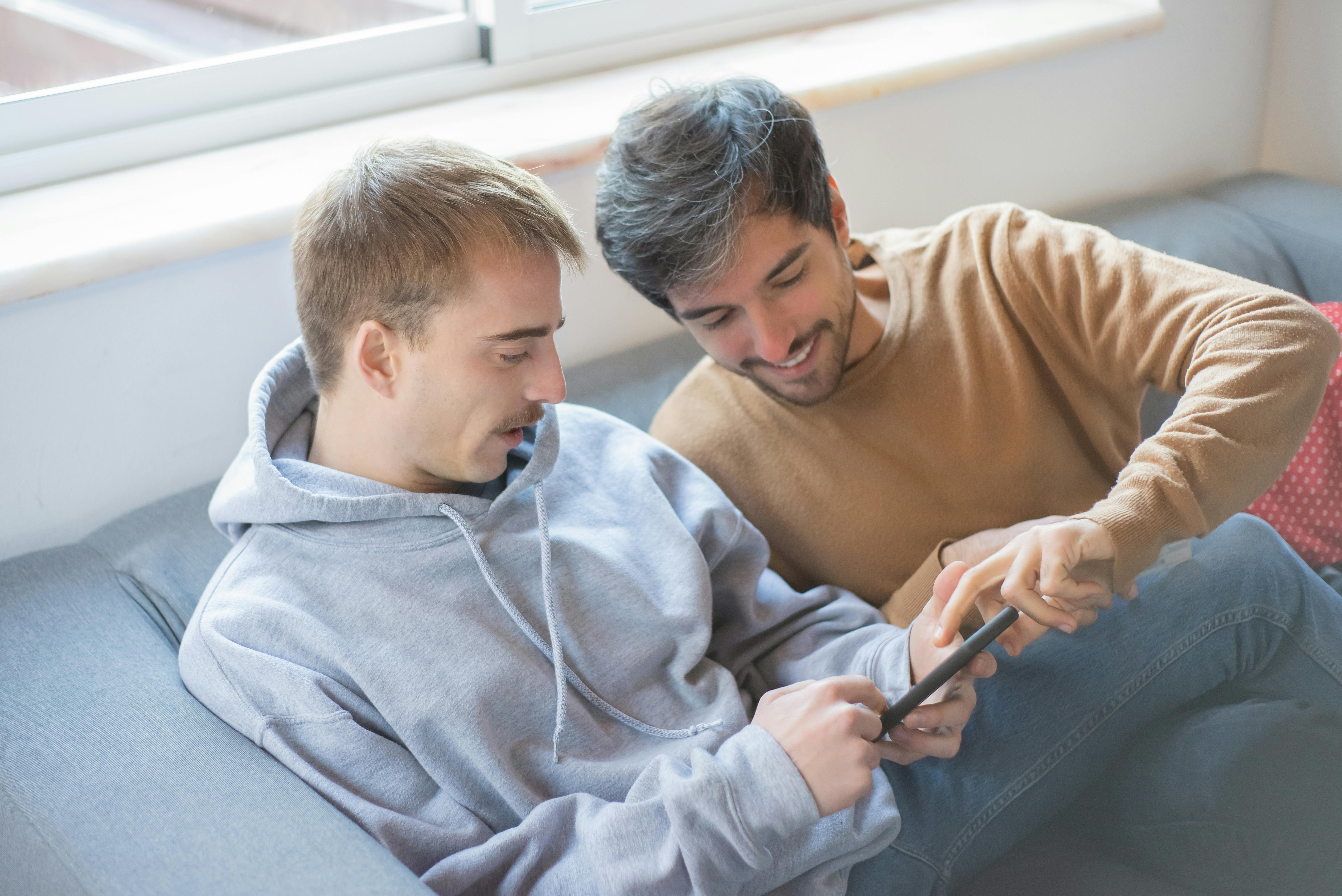 Photograph of Men Using a Cell Phone · Free Stock Photo