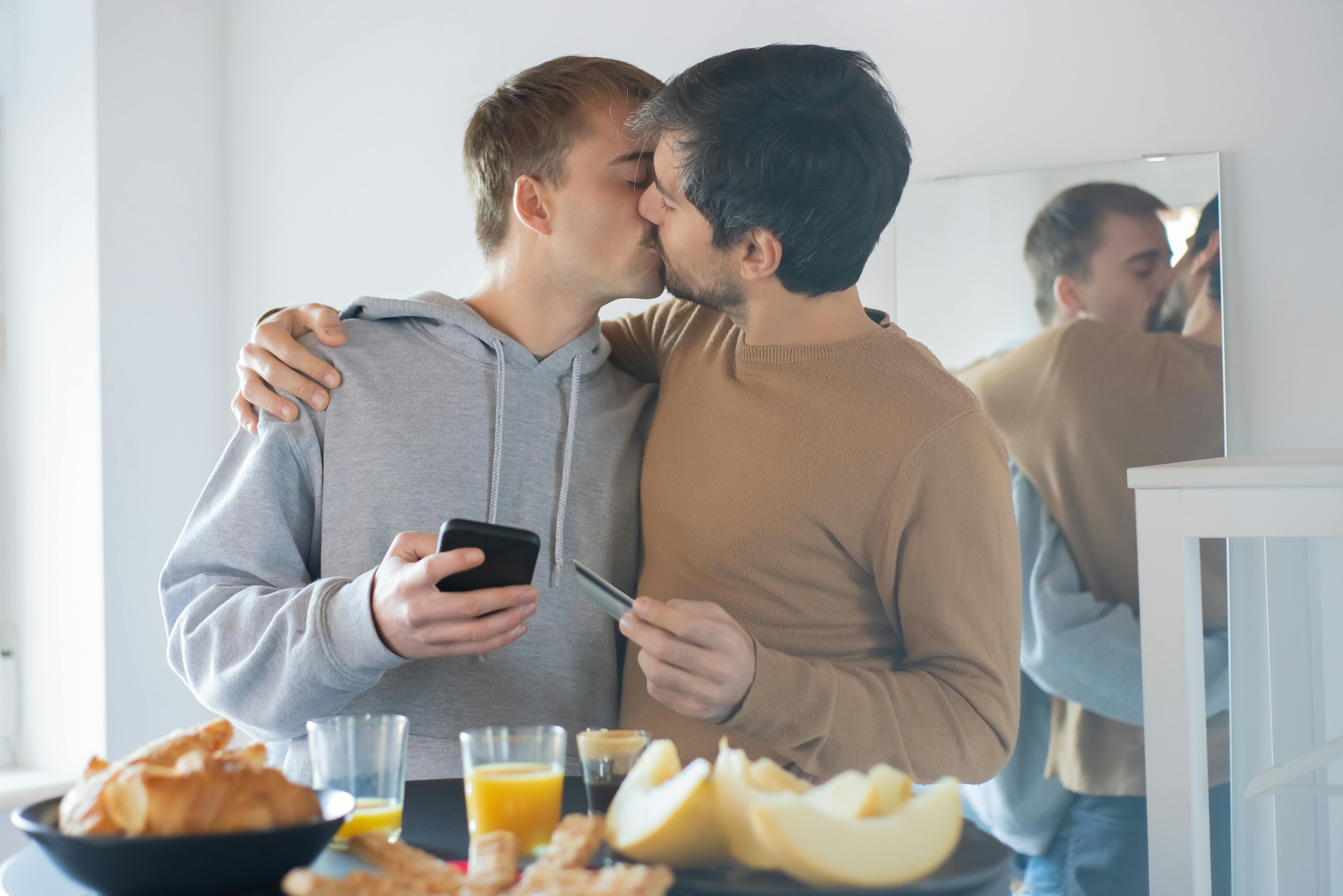 photo of a couple kissing near a table with food