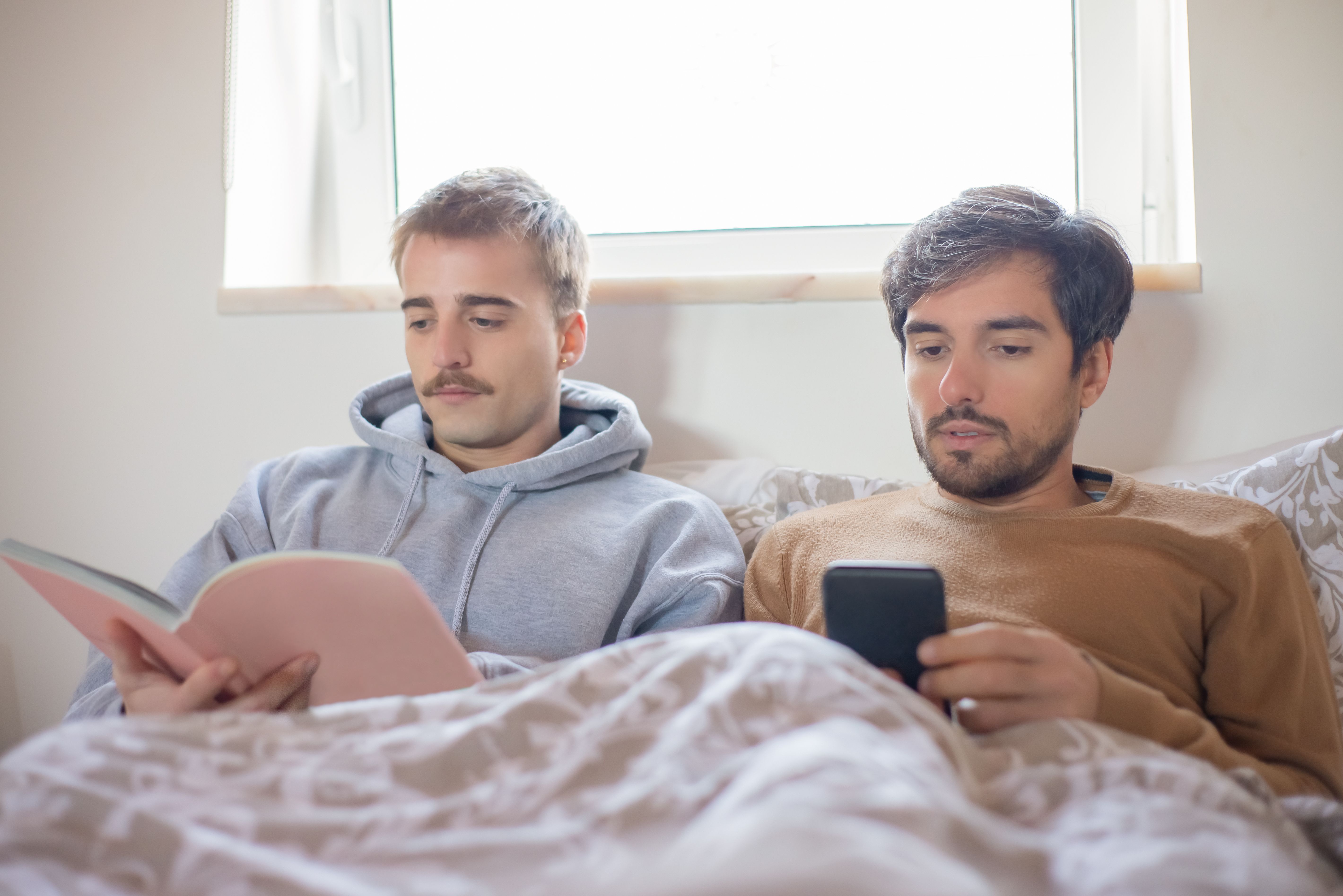 Photo Of Men Looking At A Black Cell Phone Free Stock Photo photo-of-men-looking-at-a-black-cell-phone-free-stock-photo