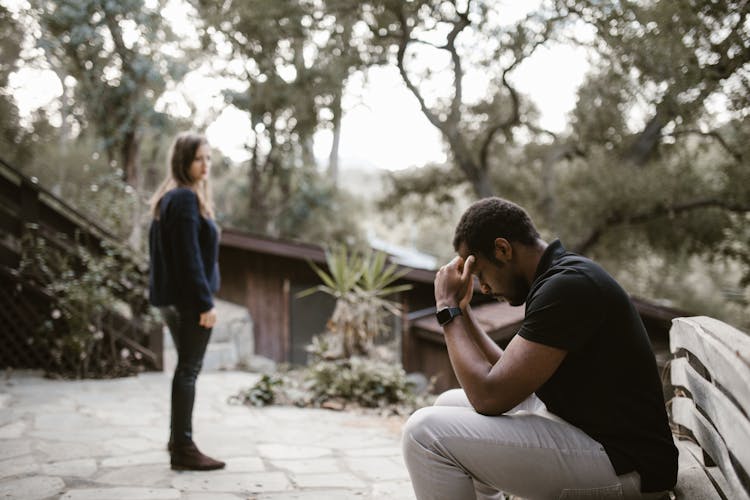 Woman Looking At The Stressed Man 