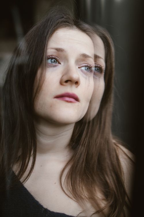 The Emotional Hangover: Why Toxic Relationships Leave You Feeling Empty 1 Woman with emotional, reflective expression - healing from toxic relationships