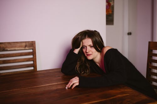 A Sad Woman Leaning on the Table