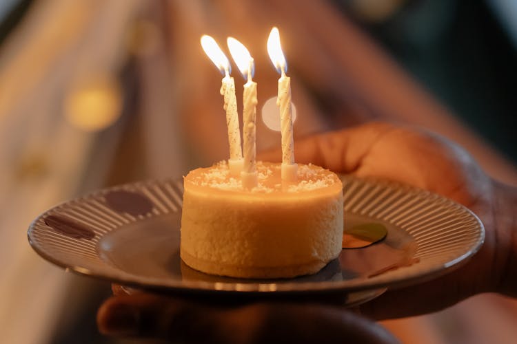 Close-Up Photograph Of A Birthday Cake With Lit Candles