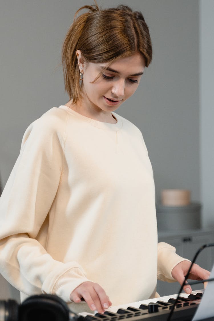 A Woman Playing The Keyboard