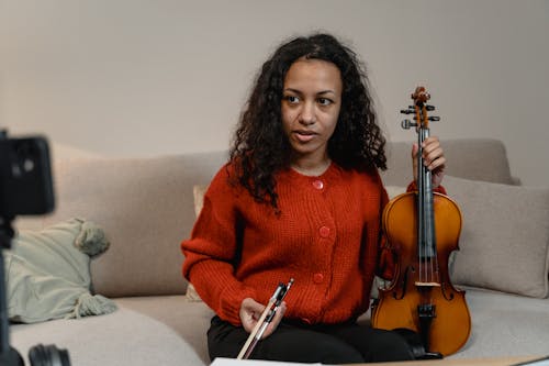 A Woman Holding a Violin While Stiing