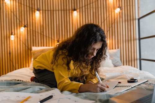 Woman Writing on a Notebook