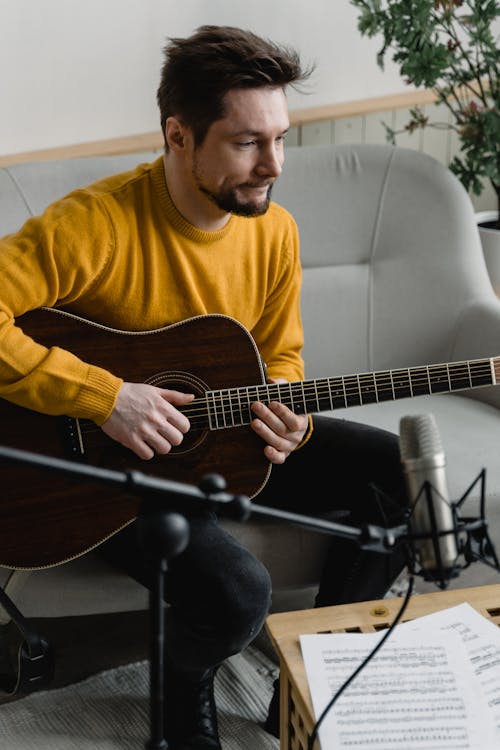 A Man Playing an Acoustic Guitar