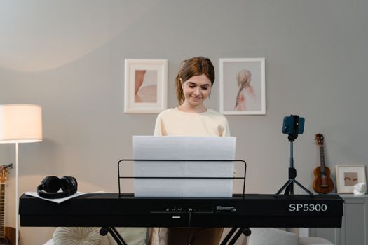 A woman practices her musical talents on an electronic keyboard in a cozy indoor setting.