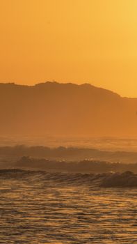 Serene ocean view during golden hour at Warrnambool, capturing waves and warm tones.