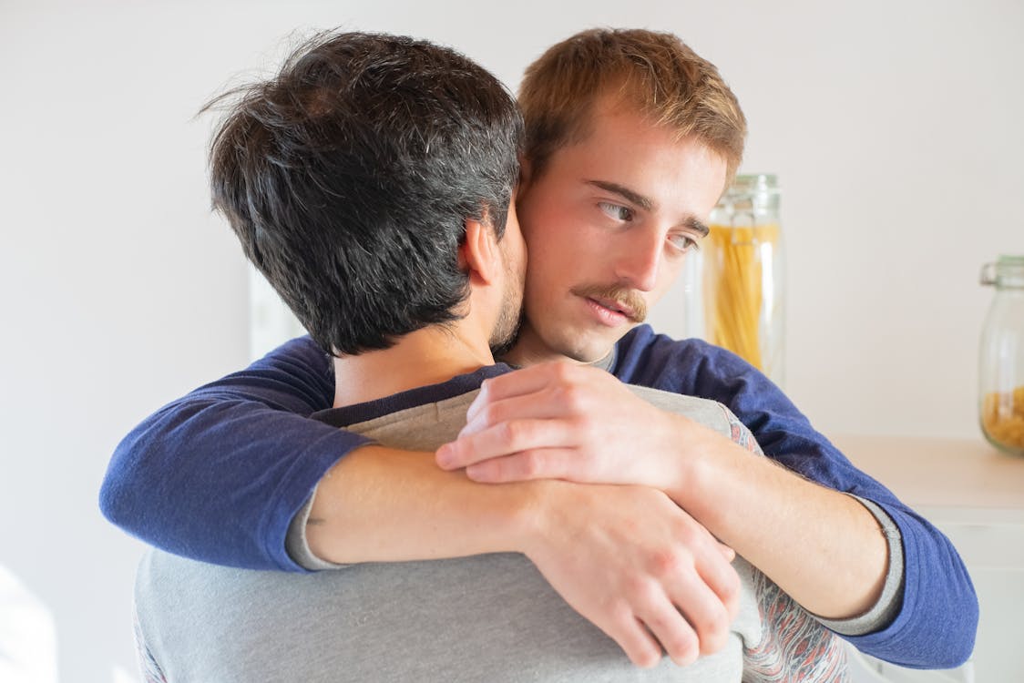 Men Hugging Each Other in Close-up Photography ยท Free Stock Photo