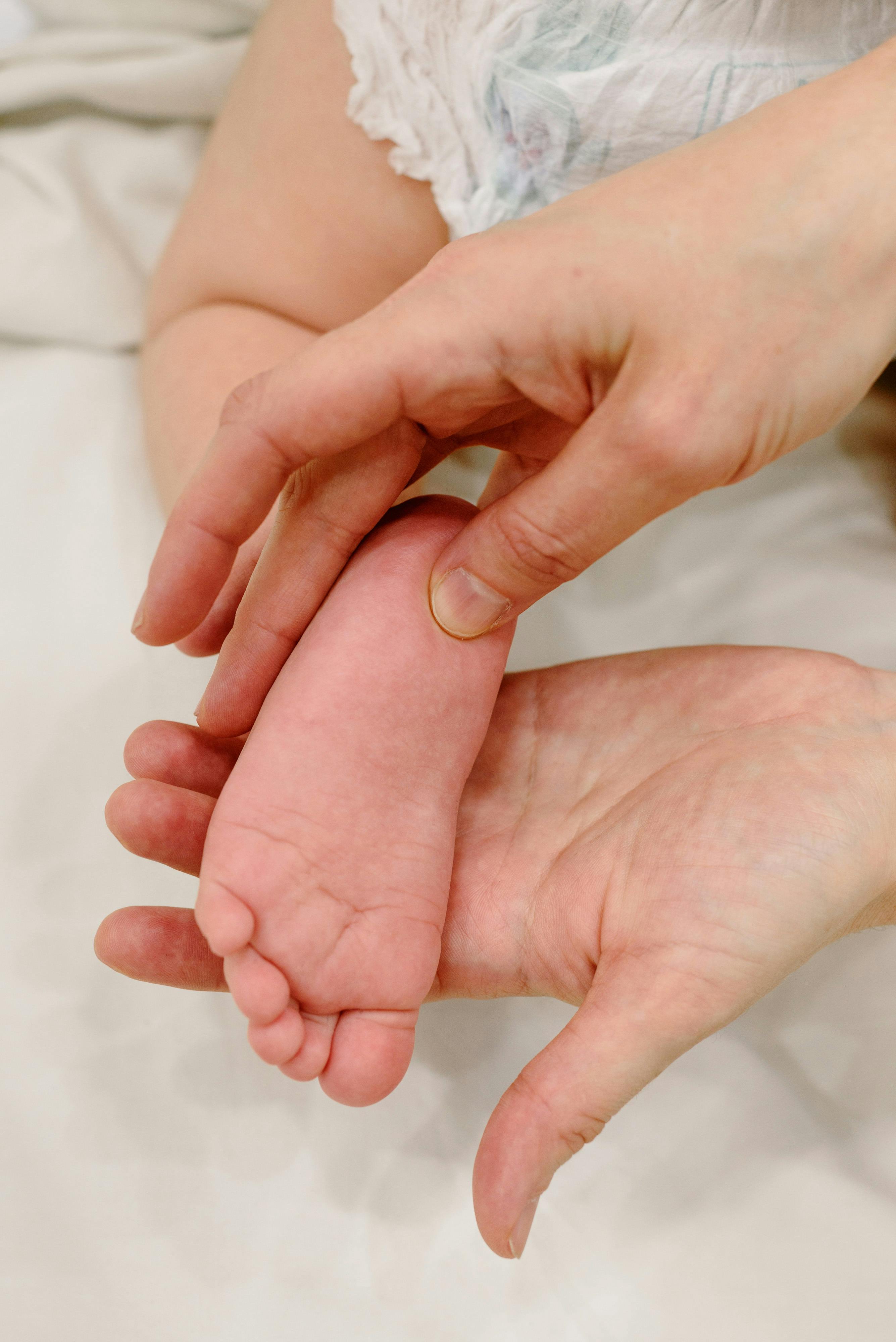 person holding a baby s foot