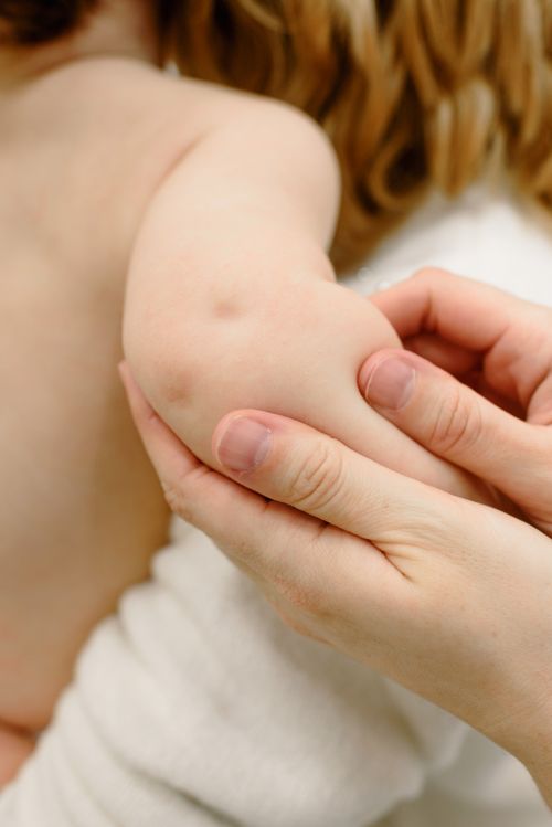 Free Close-up image of a baby receiving a gentle arm massage, highlighting the soothing touch. Stock Photo