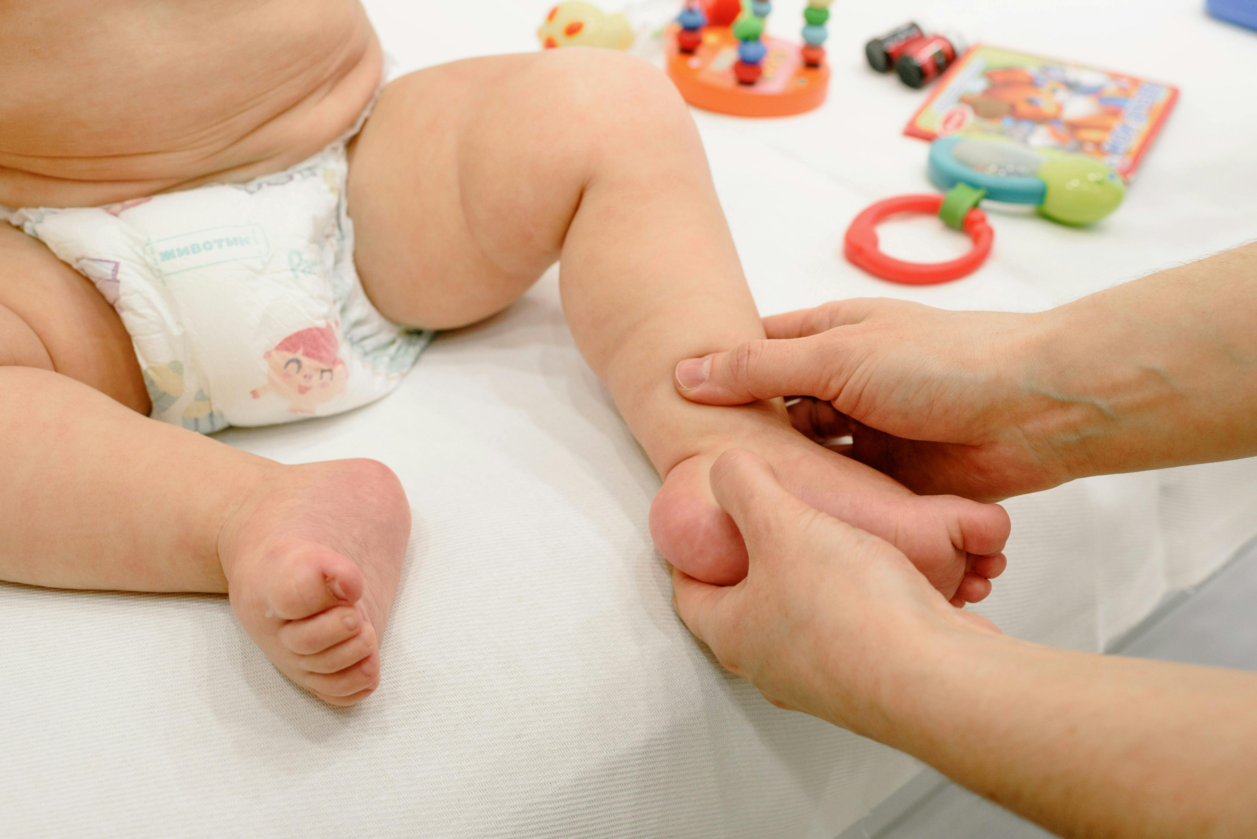 hands massaging the baby s foot