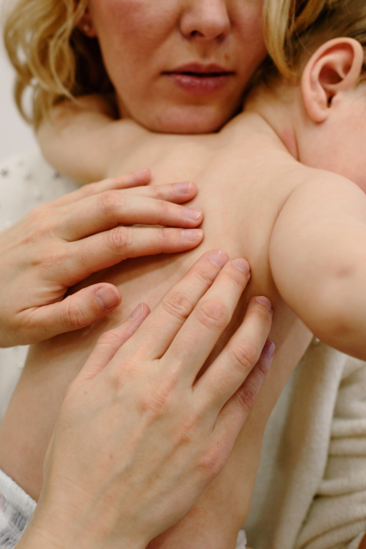 Mother holding and gently comforting her baby