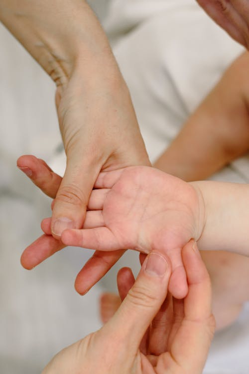 Free Person Massaging a Baby's Hand Stock Photo