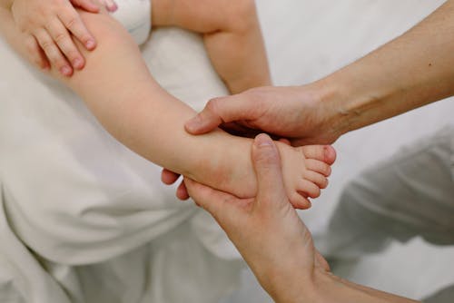 Free Baby Having a Foot Massage Stock Photo