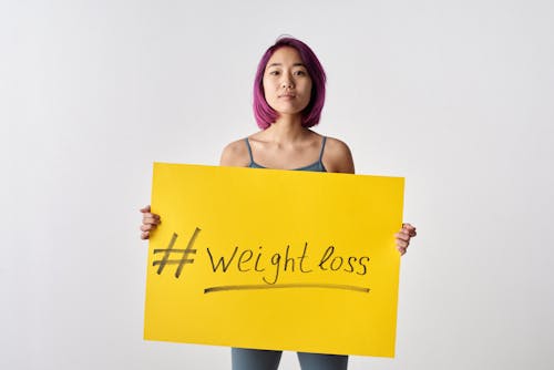 Woman Holding Yellow Poster 