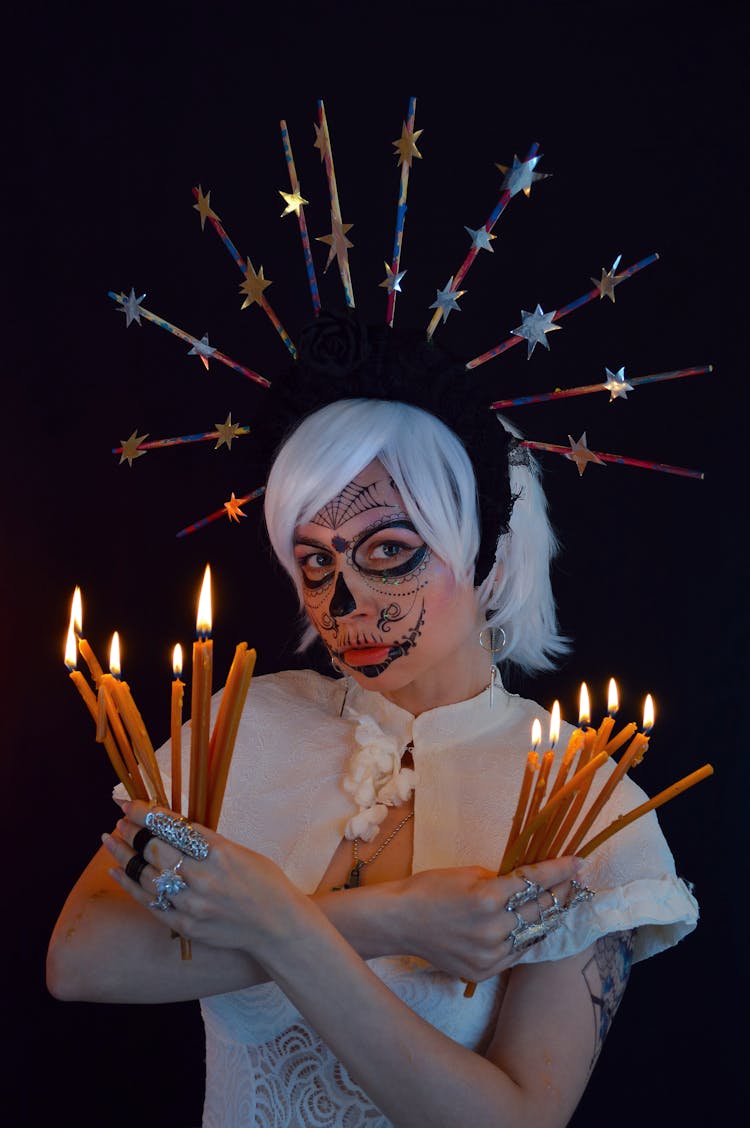 Calm Young Enchantress With Burning Candles In Black Studio