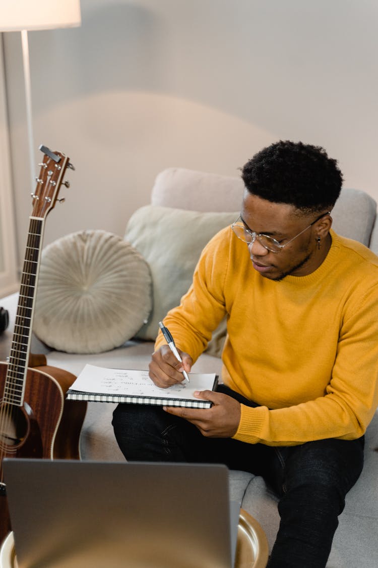 Man Writing On A Paper