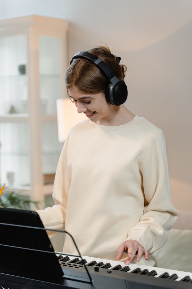 A Woman Playing The Keyboard