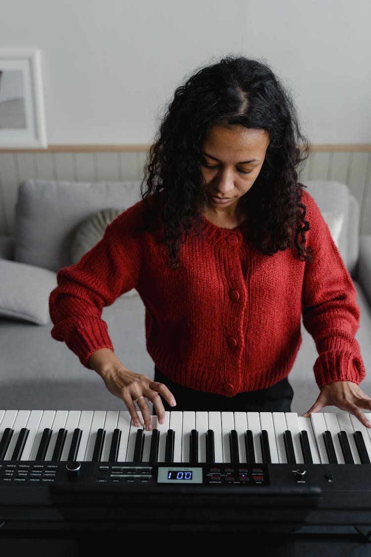 A Woman Playing The Keyboard