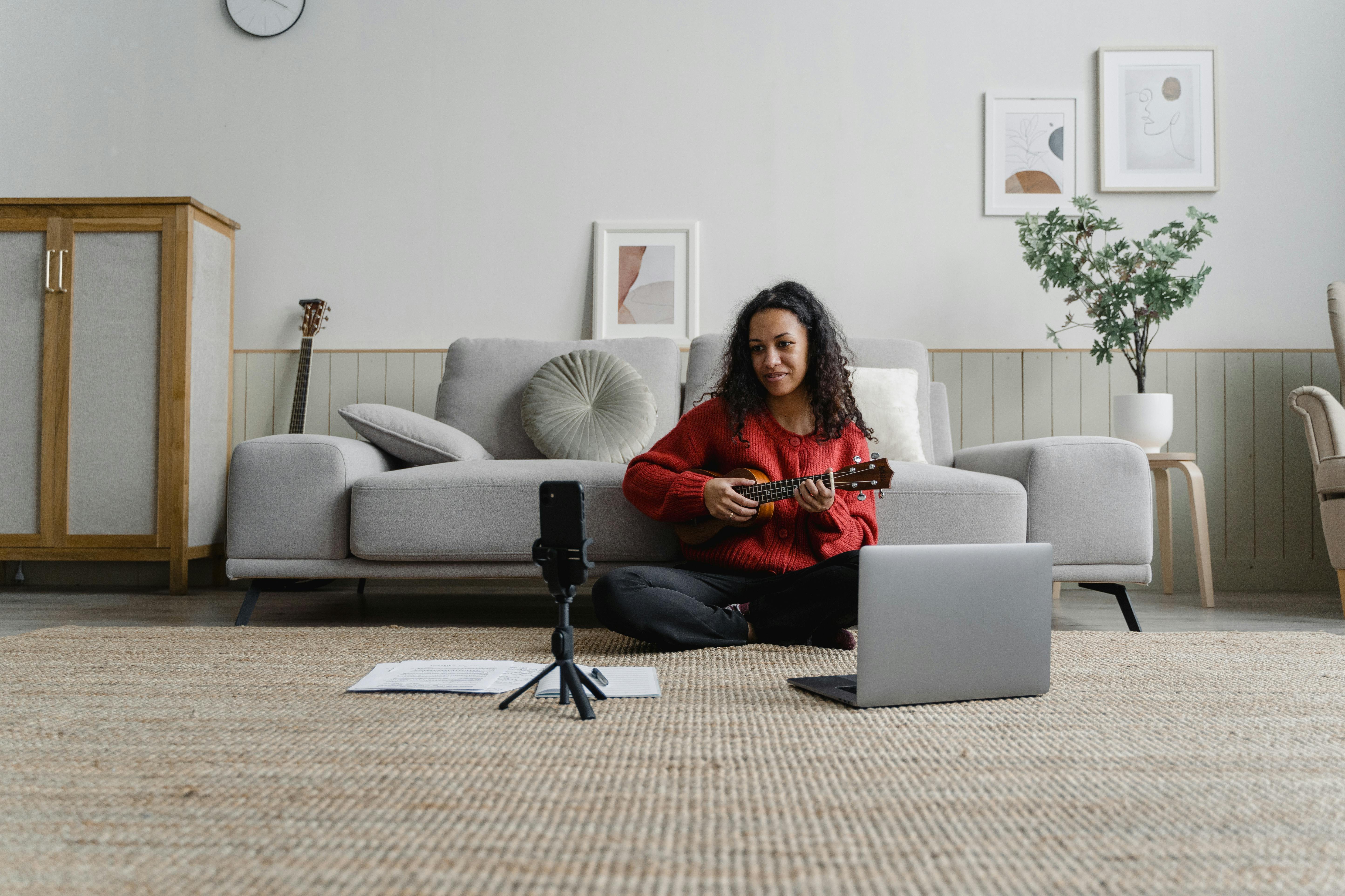 musician filming video on cellphone at home