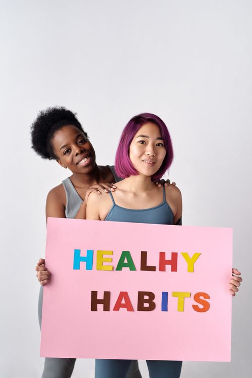Free Two diverse women holding a healthy habits sign, promoting wellness. Stock Photo