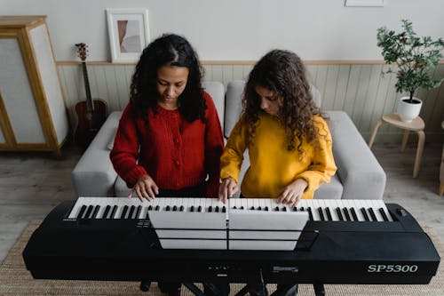 Free Curly Haired Women Playing Piano  Stock Photo
