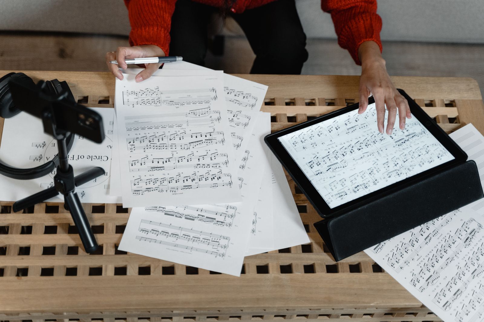 Musicians analyzing notation and musical materials in a studio workspace